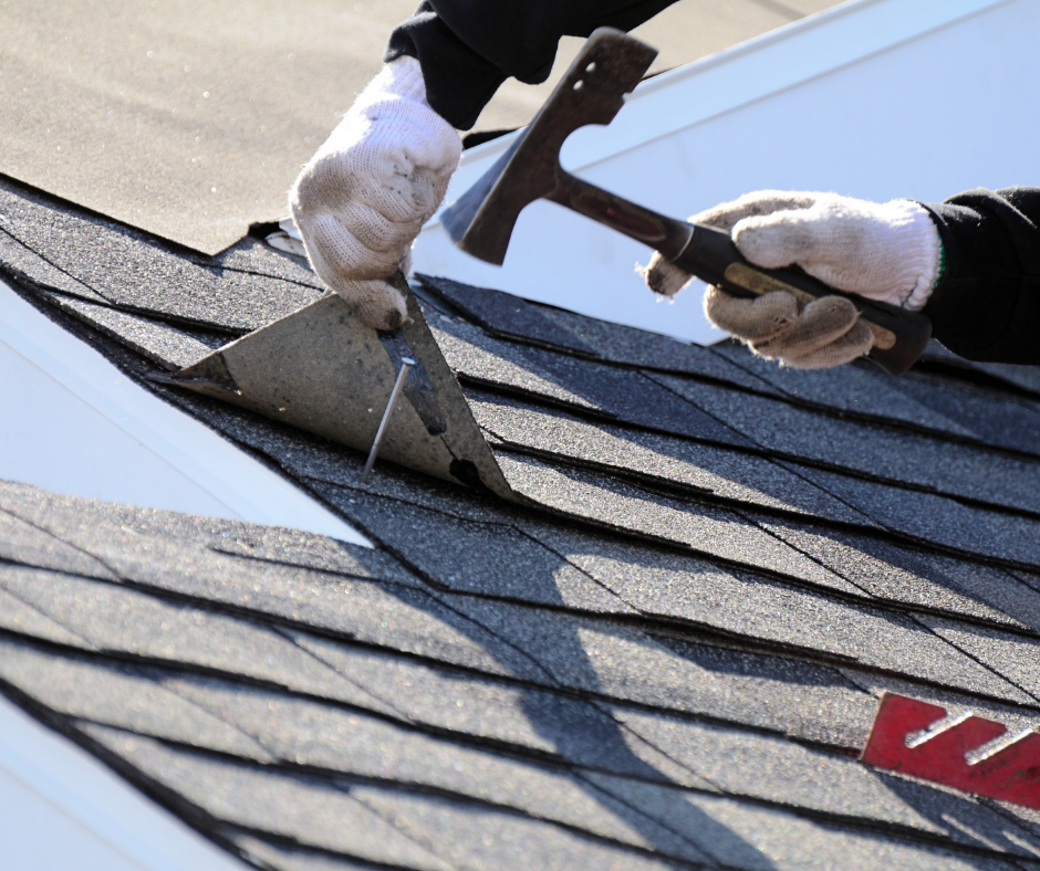 A person is working on a roof with a hammer