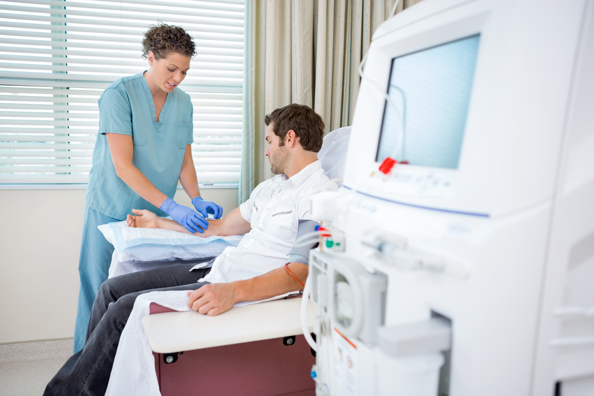 A nurse is examining a patient 's leg in a hospital room.