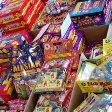 A bunch of boxes of fireworks are stacked on top of each other.