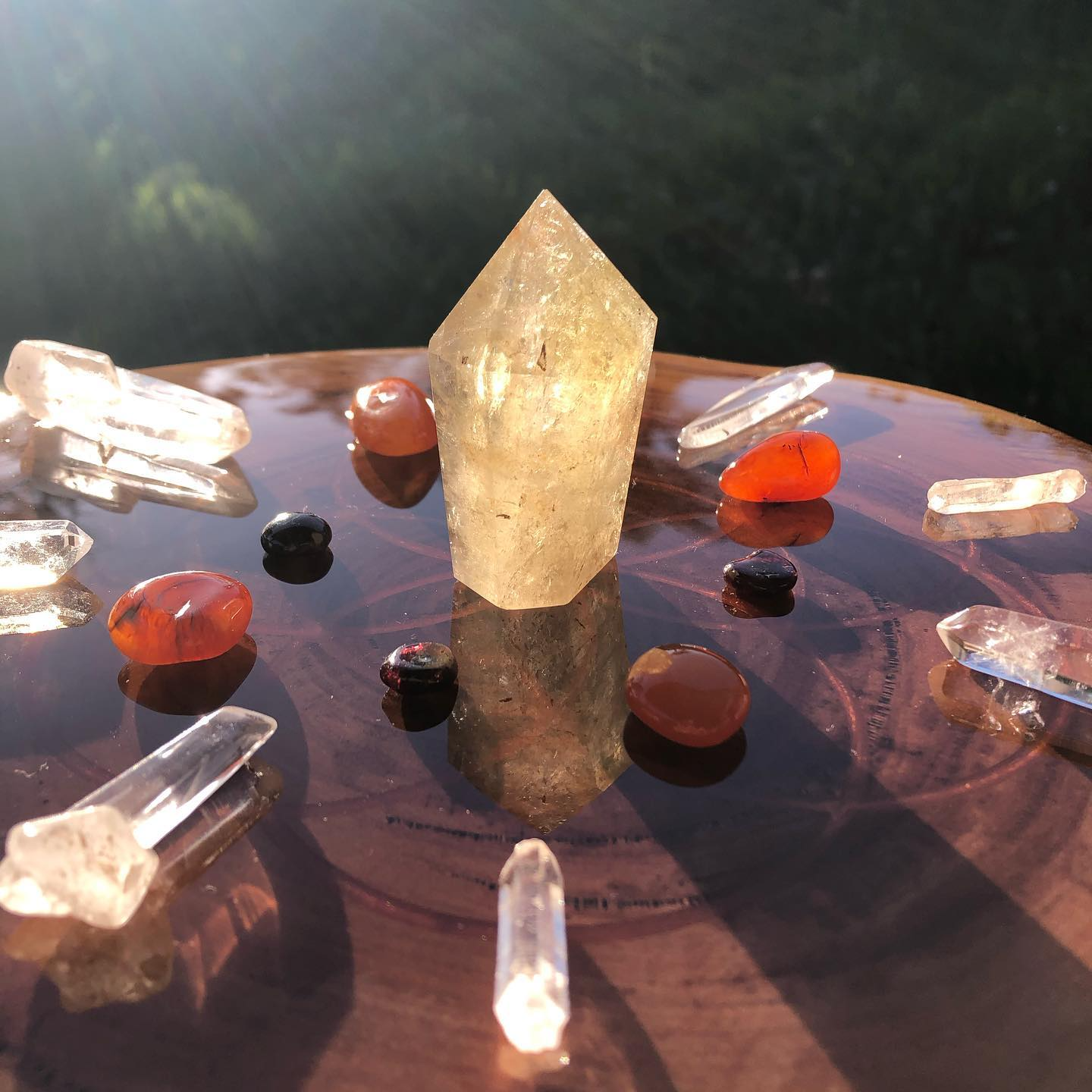 A crystal sitting on top of a table surrounded by other crystals