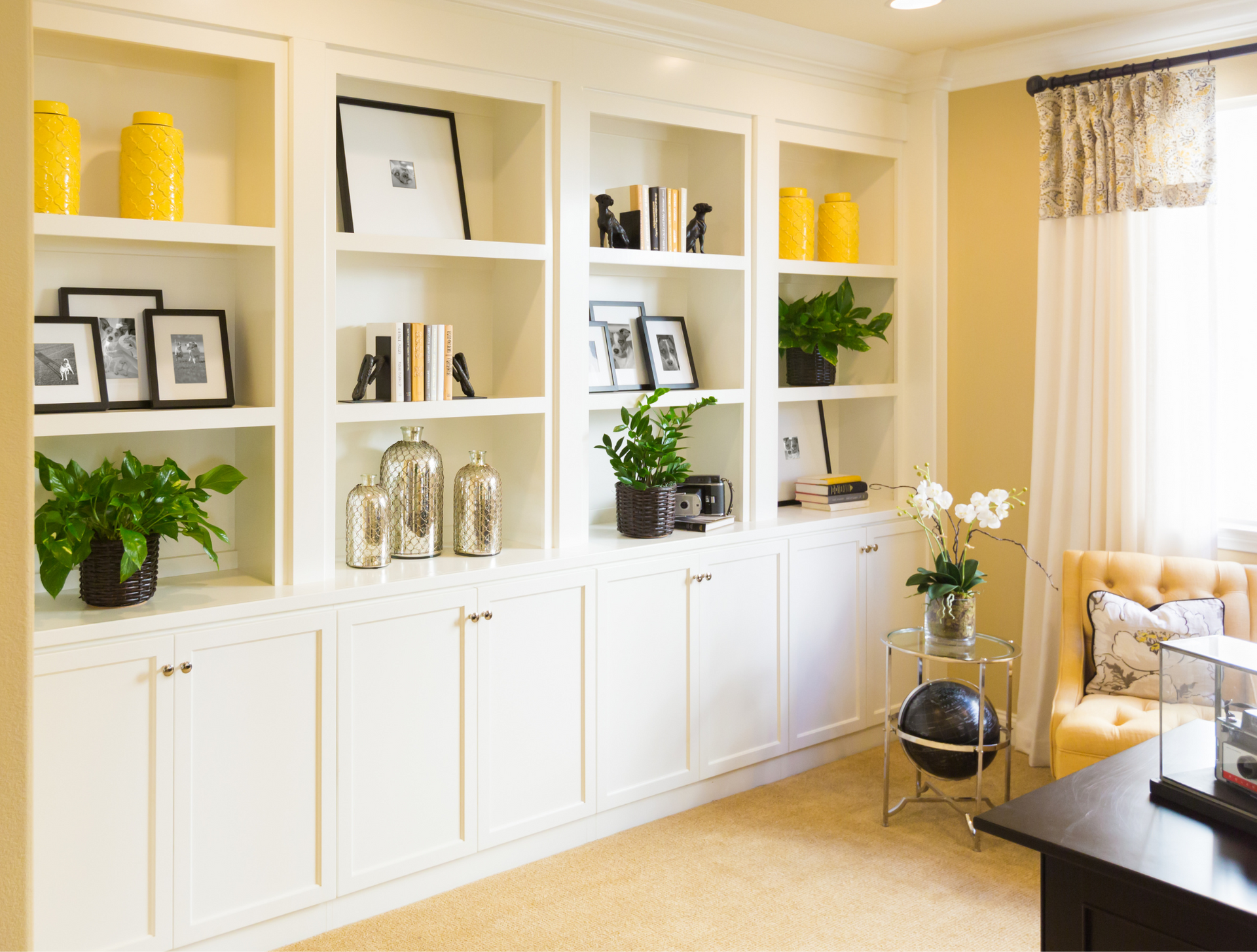 A living room with a lot of shelves and cabinets