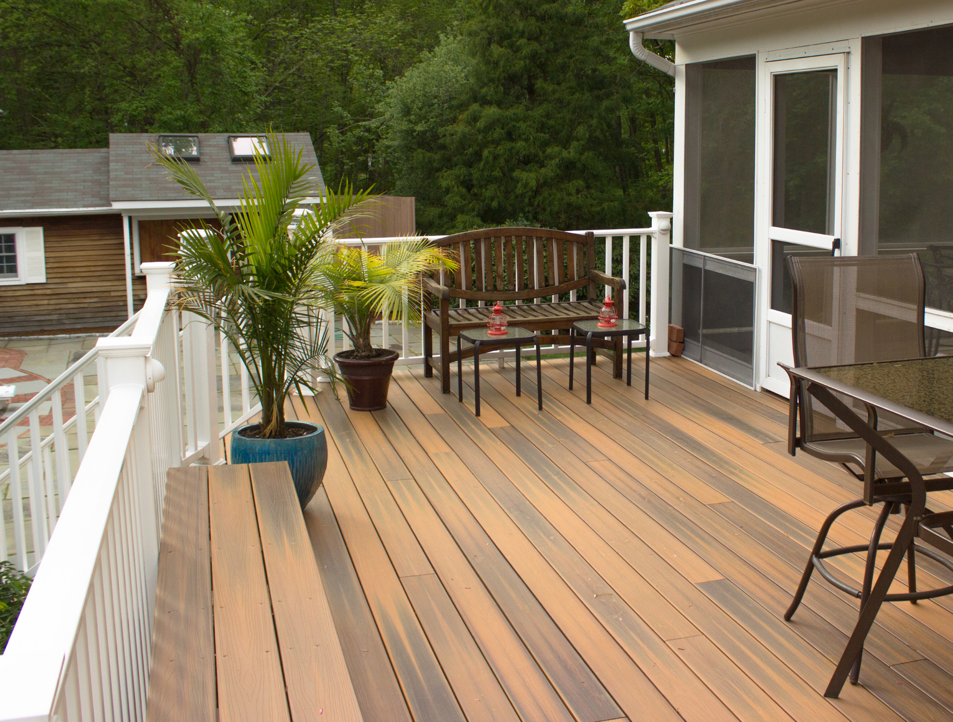 A wooden deck with a table and chairs on it
