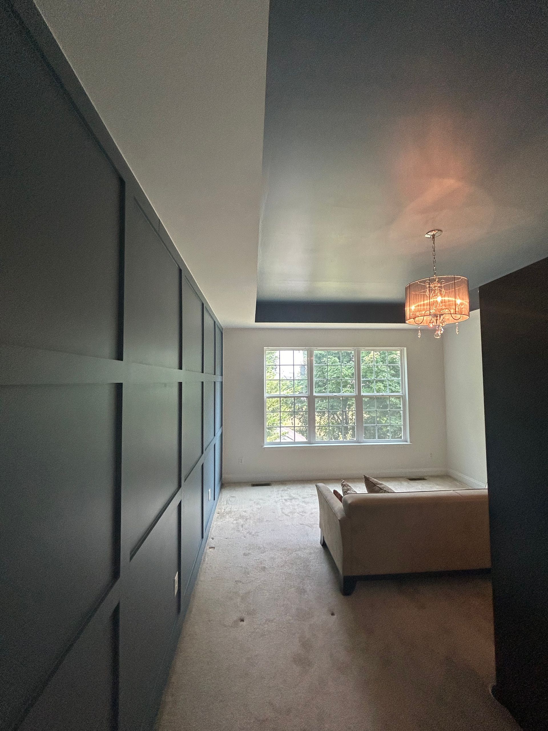 A living room with a couch and a chandelier