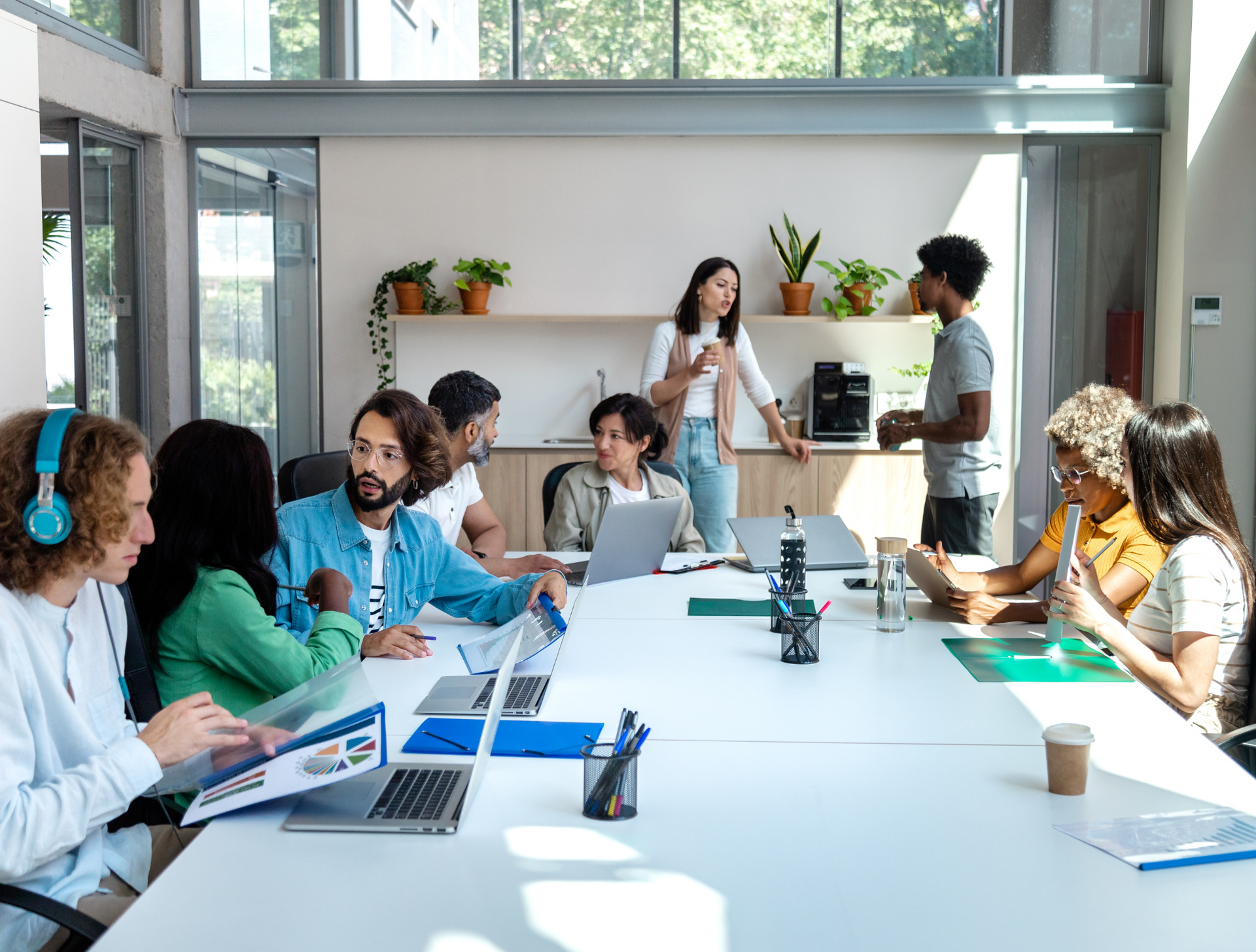 A group of people are sitting around a long table in a conference room.