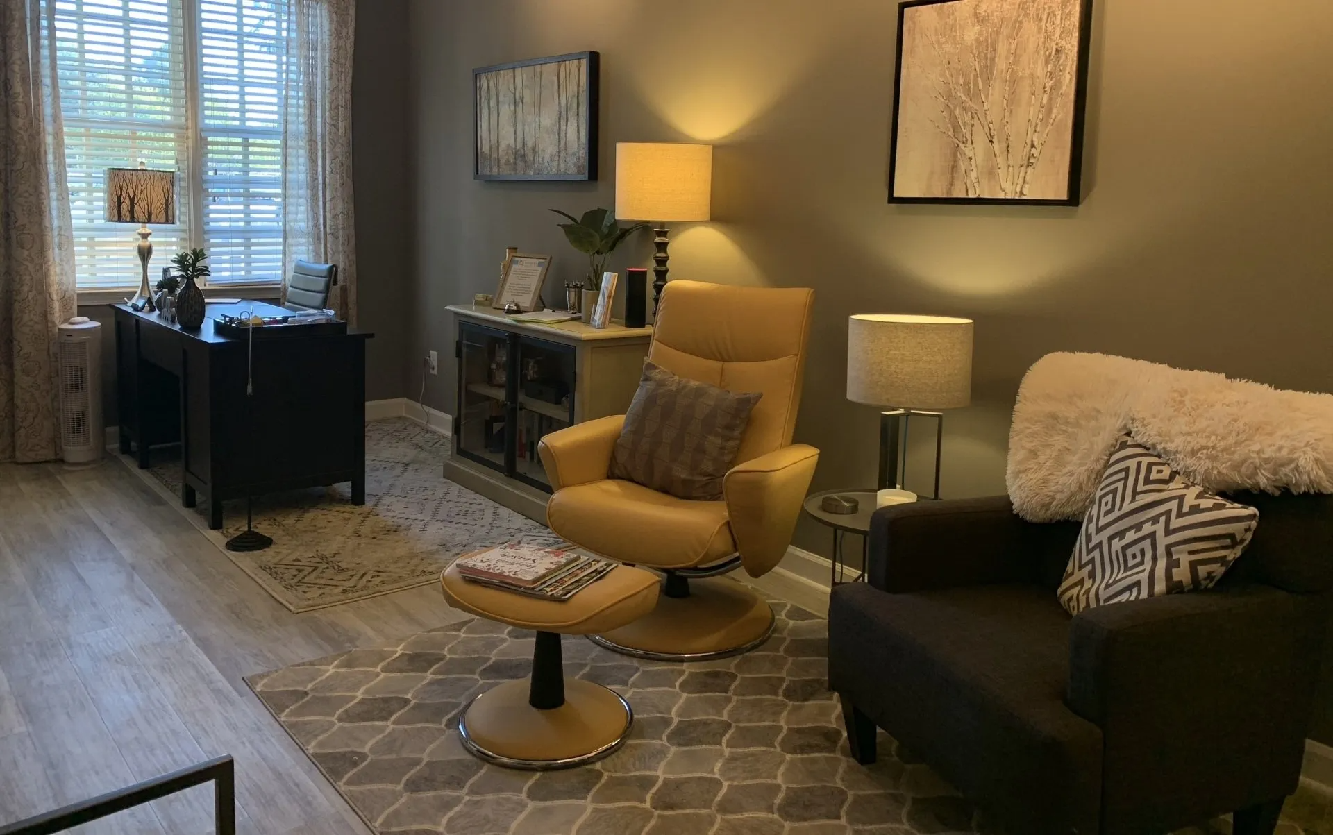 A living room with two chairs and a desk.