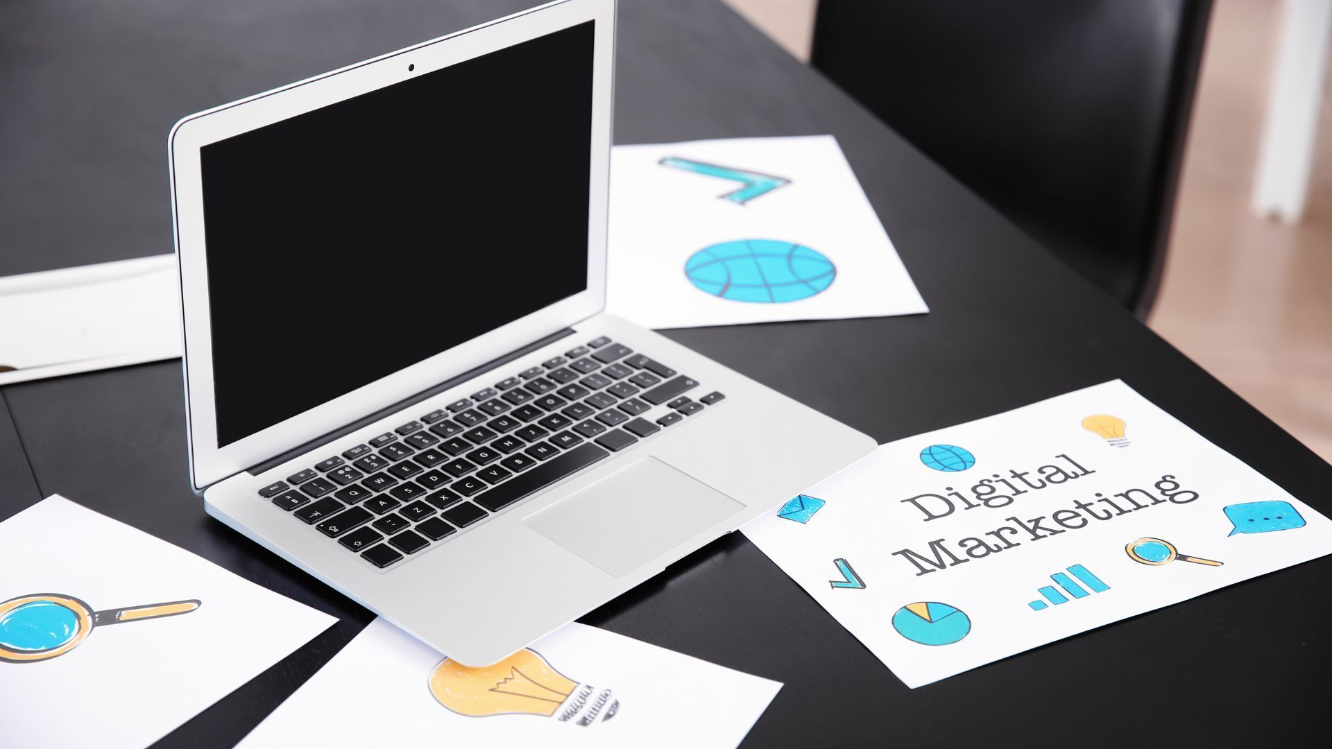 Rollers Media: Laptop, phone, and tablet showcasing a website design on a wooden desk, with accessories.