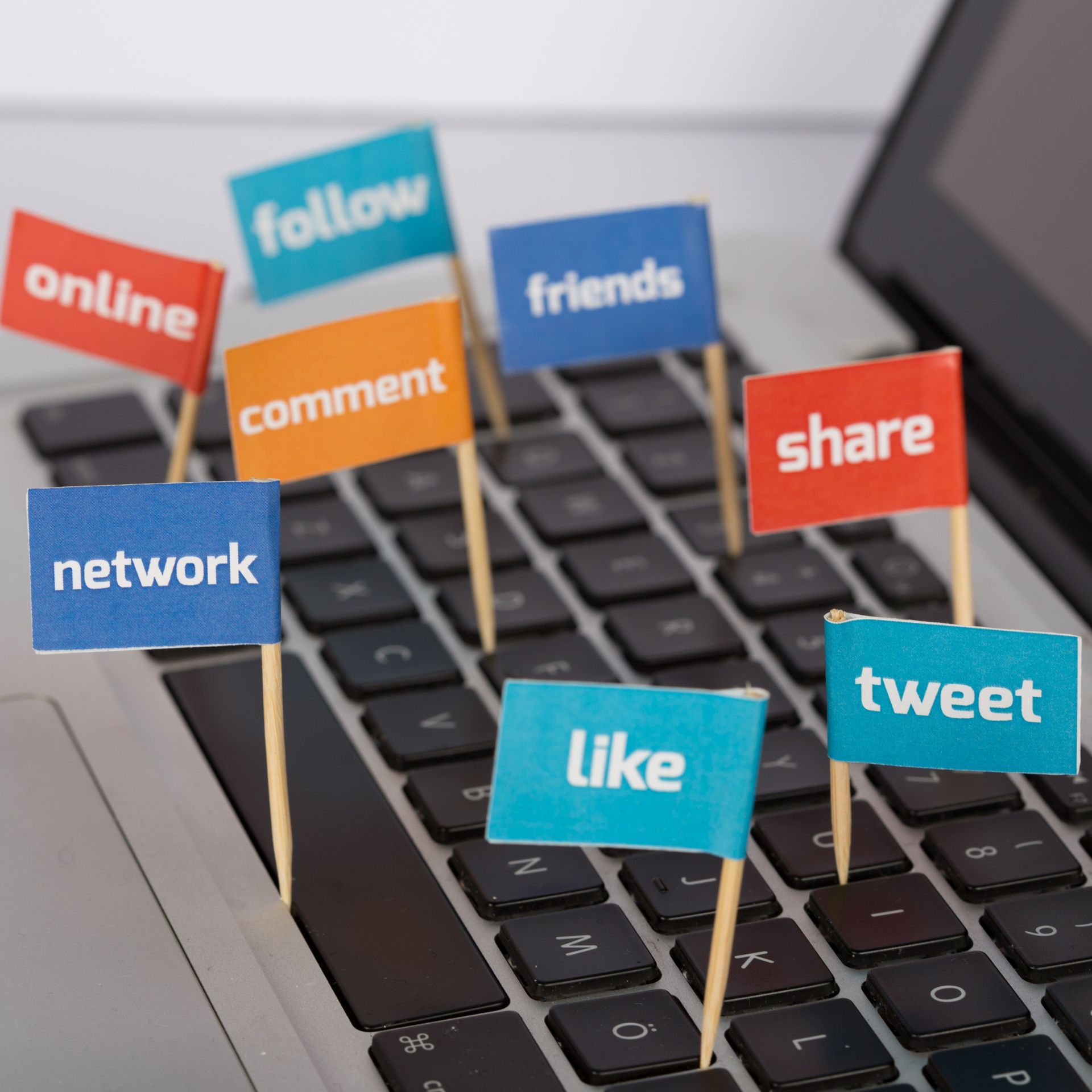 Rollers Media: Laptop keyboard with small flags displaying social media terms like 