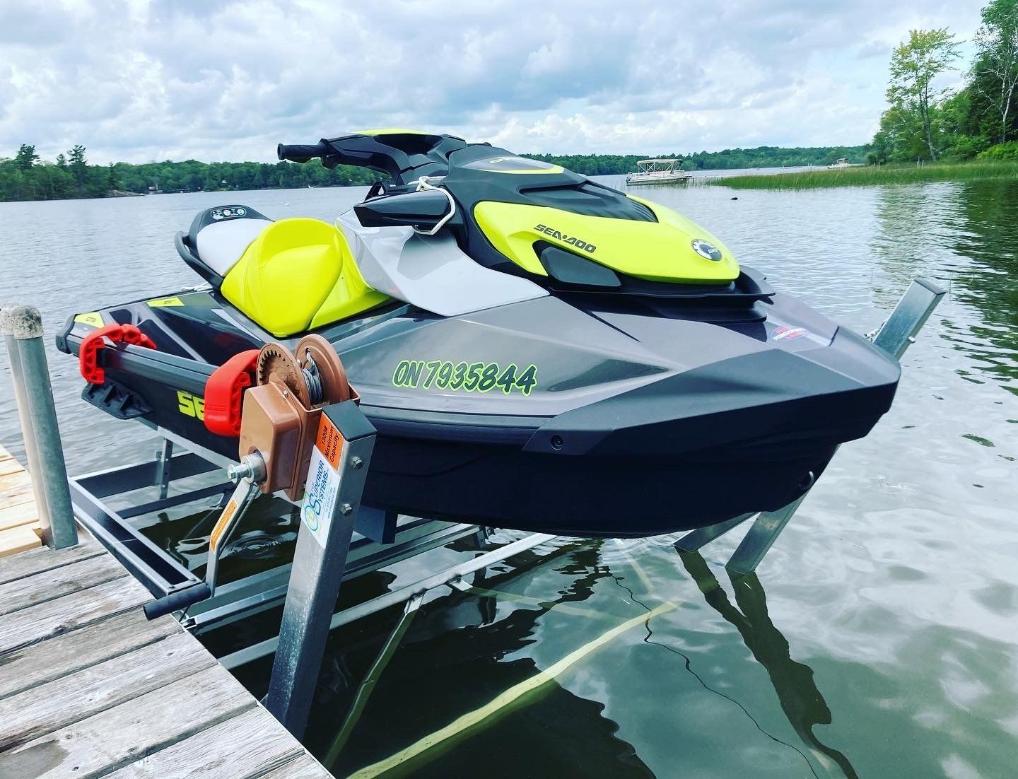 A jet ski is sitting on a dock next to a lake.