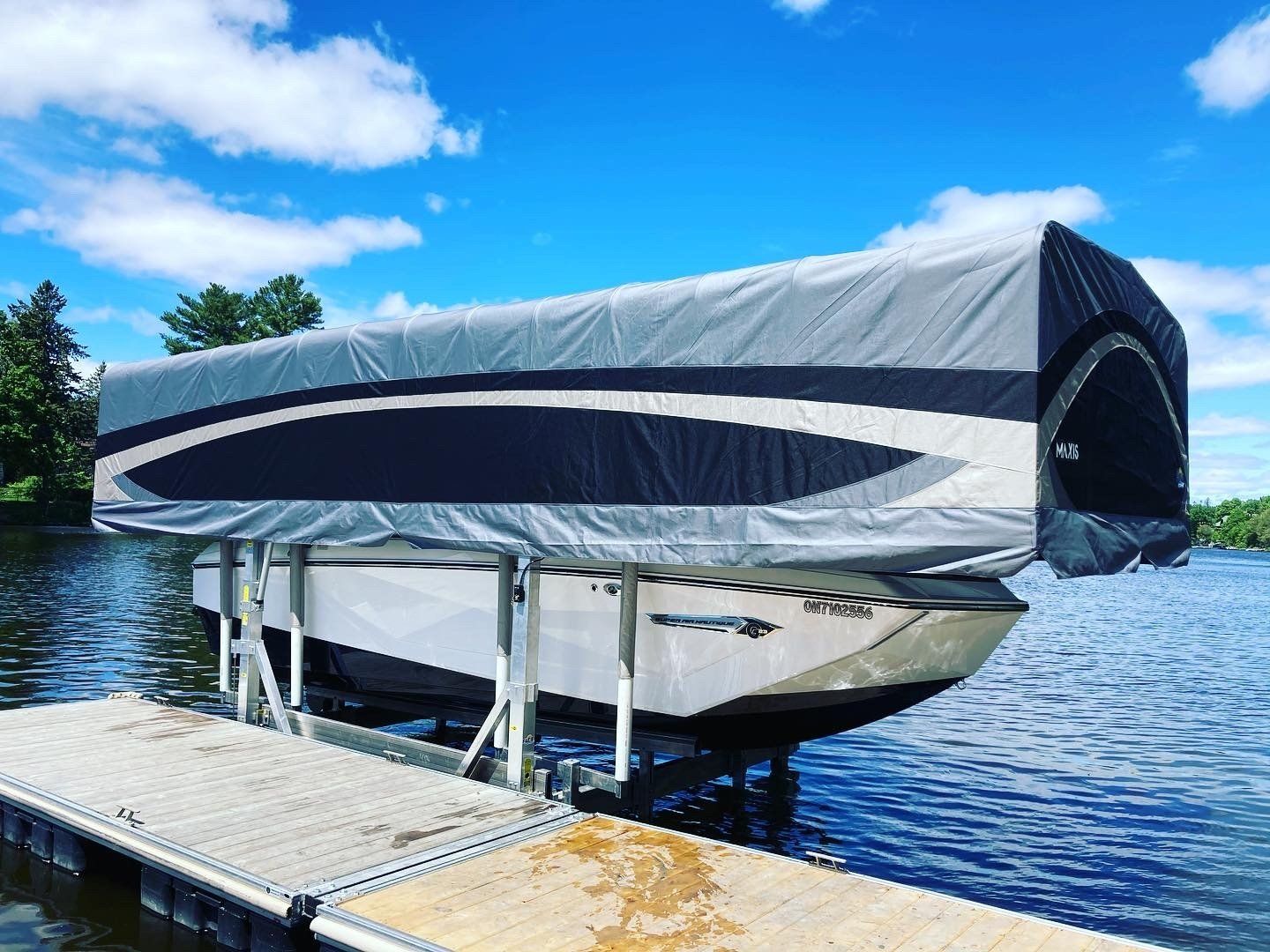A boat is sitting on top of a dock on a lake.