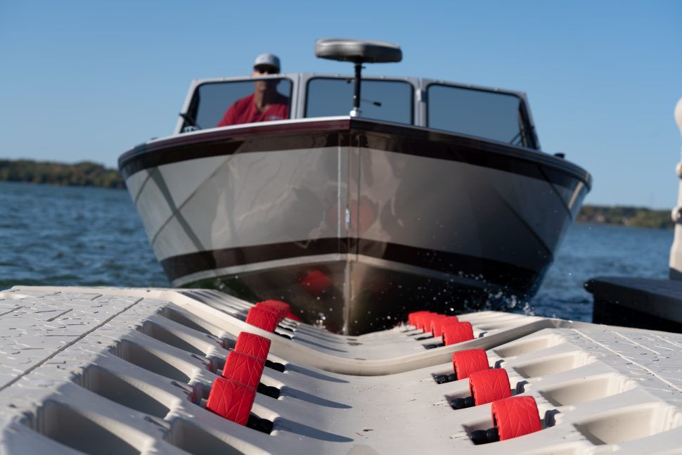 A boat is sitting on top of a dock in the water.