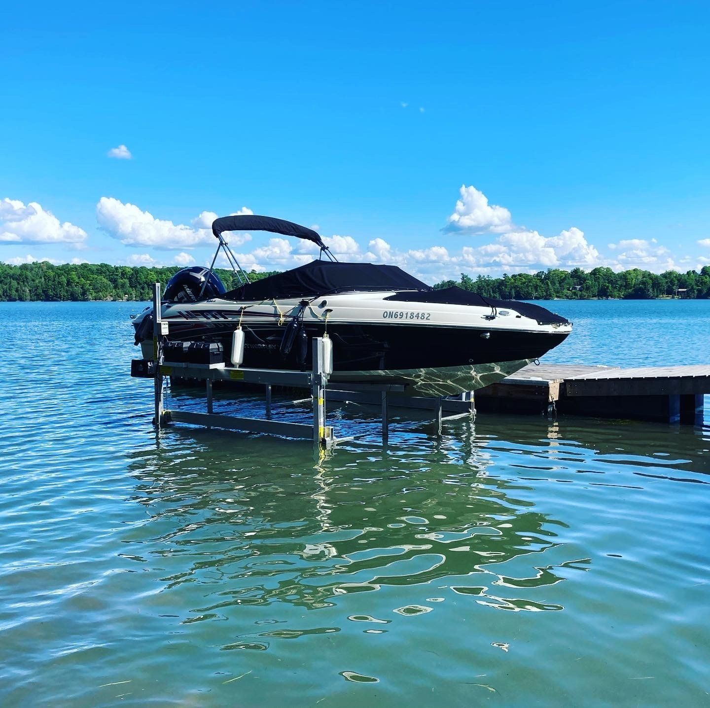 A boat is docked at a dock on a lake