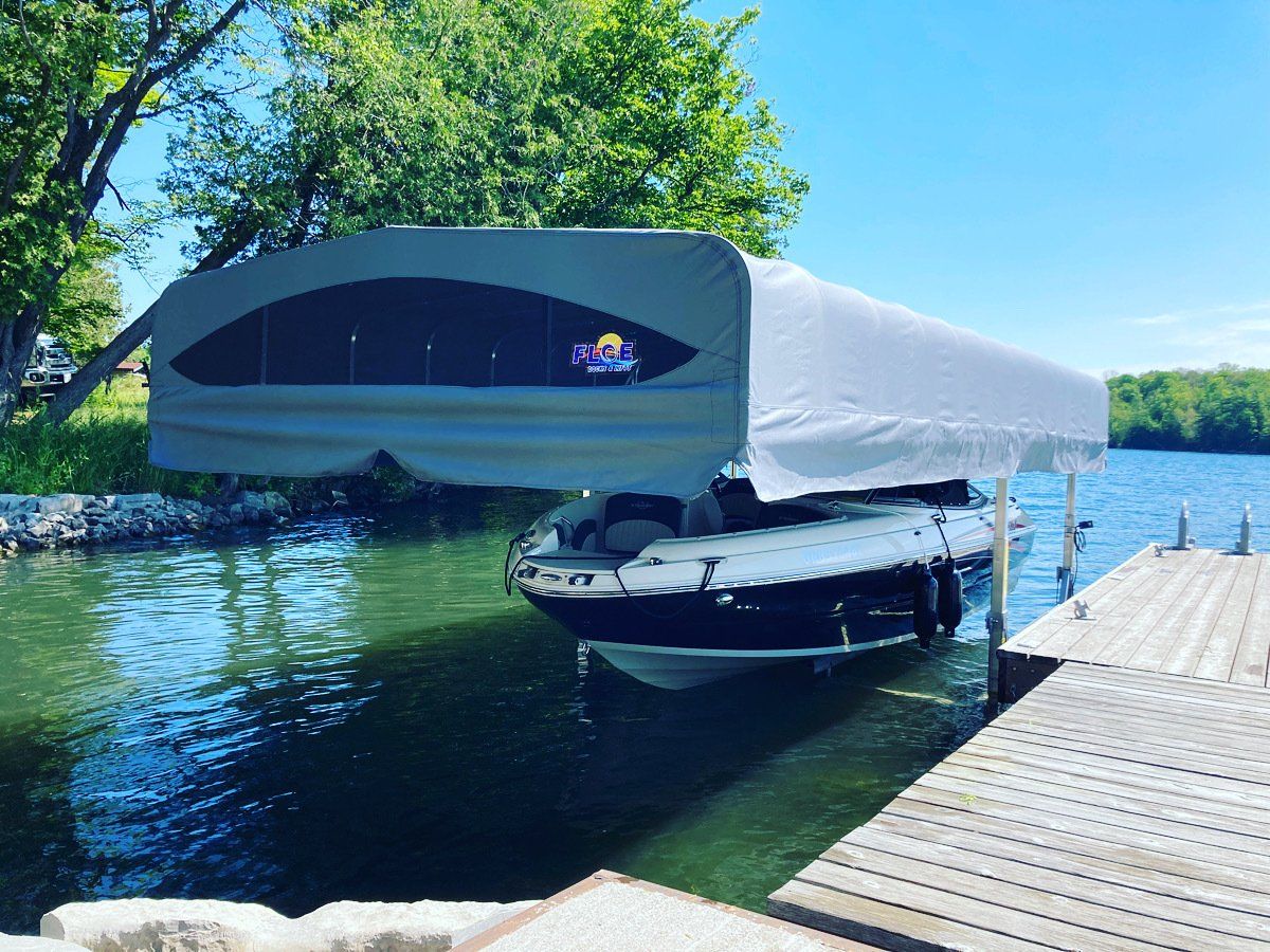 A boat is docked at a dock with a canopy over it.