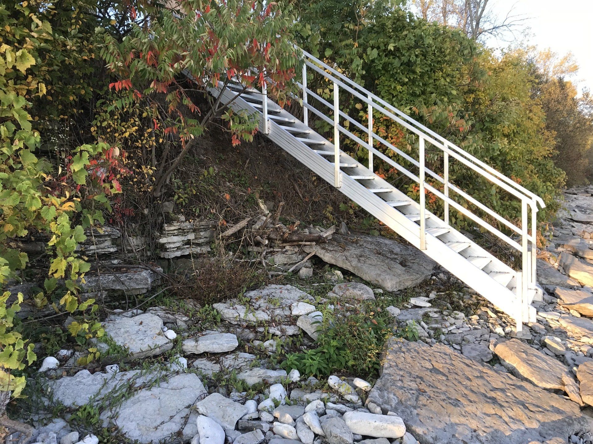 A set of stairs leading up to a rocky hillside.