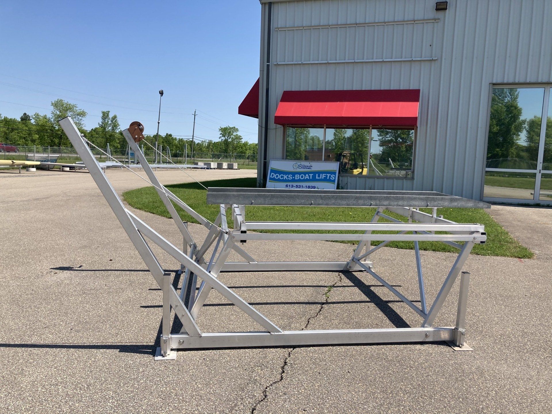 A white building with a red awning on the side of it