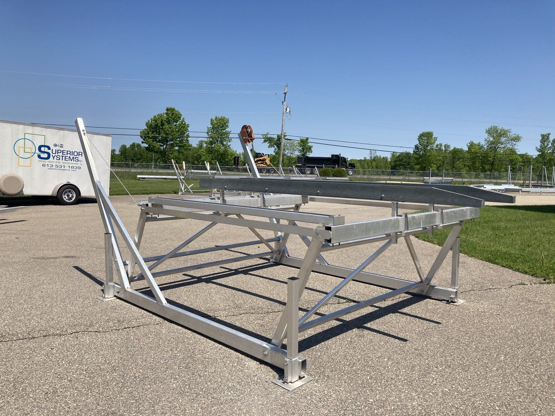 A large metal structure is sitting on the side of a road.