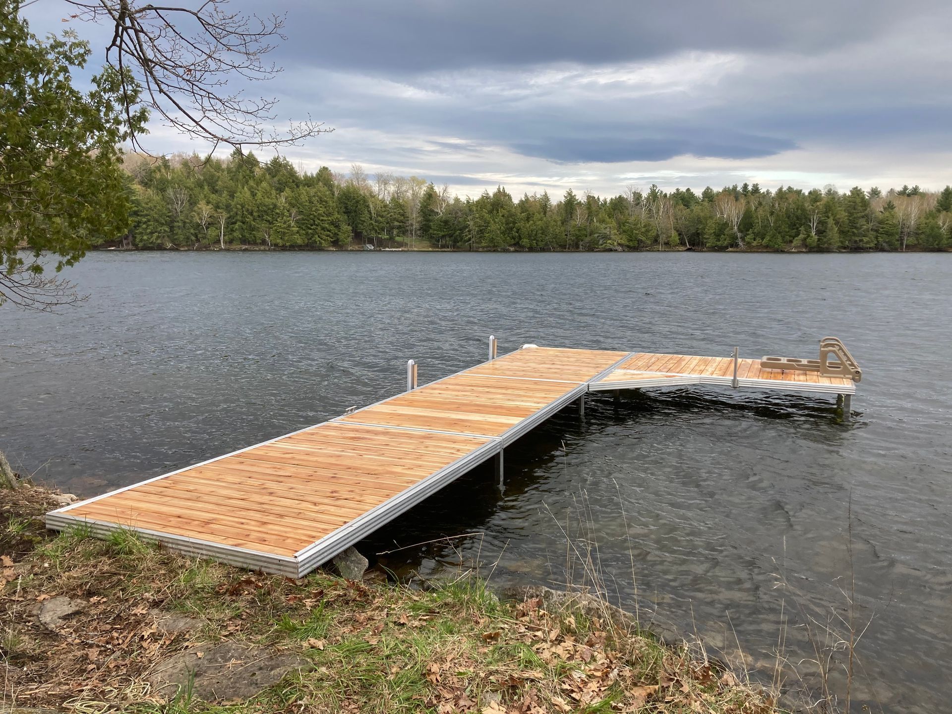 A wooden dock is sitting in the middle of a lake.