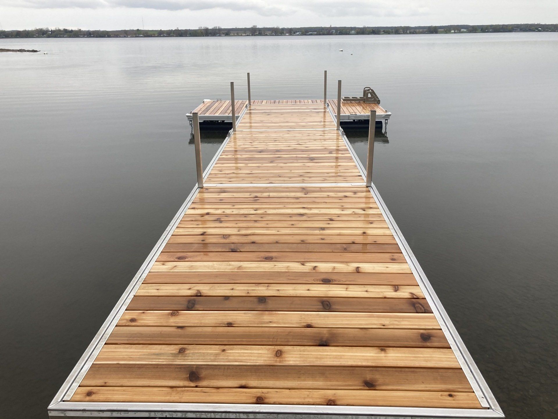 A wooden dock is sitting in the middle of a lake.