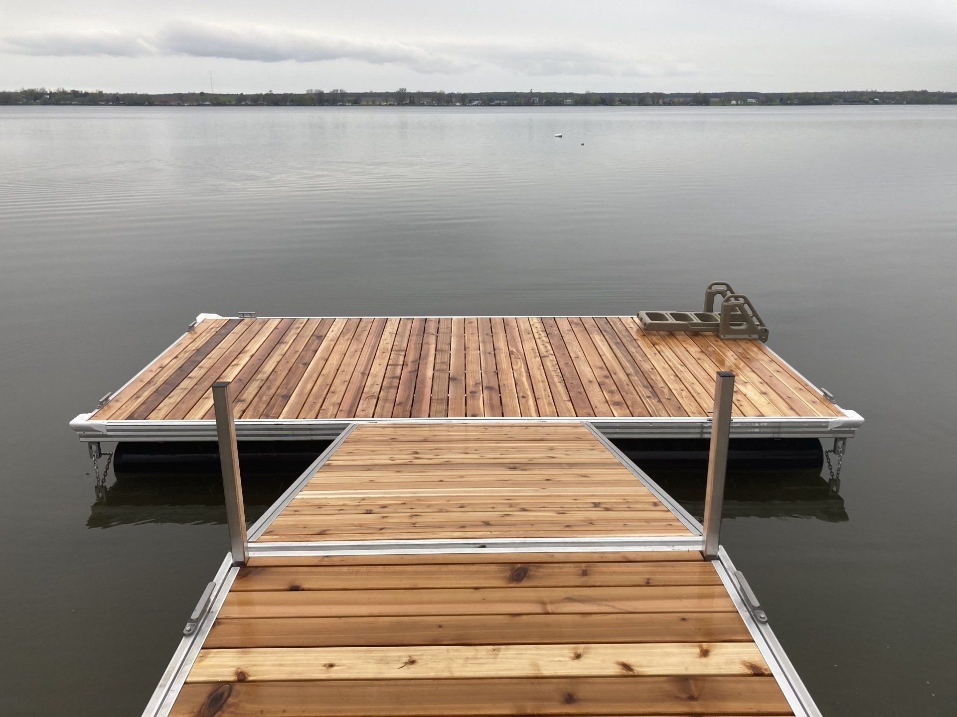 A wooden dock is in the middle of a lake.