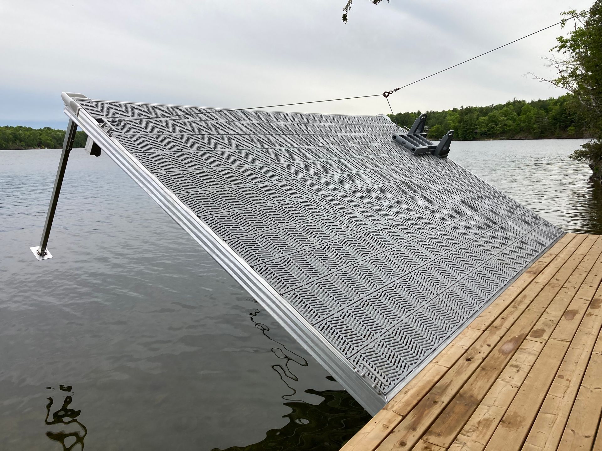 A boat is sitting on a dock next to a lake