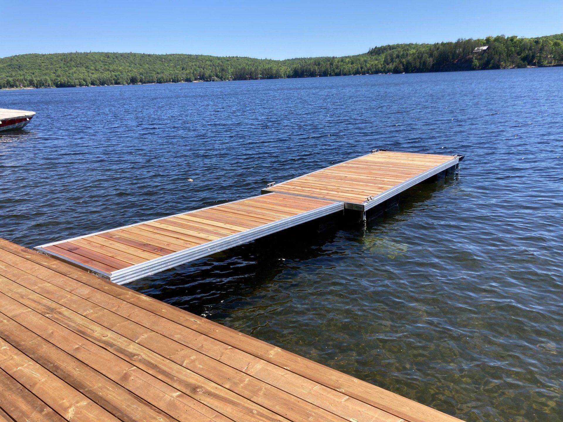 A wooden dock is sitting in the middle of a lake.