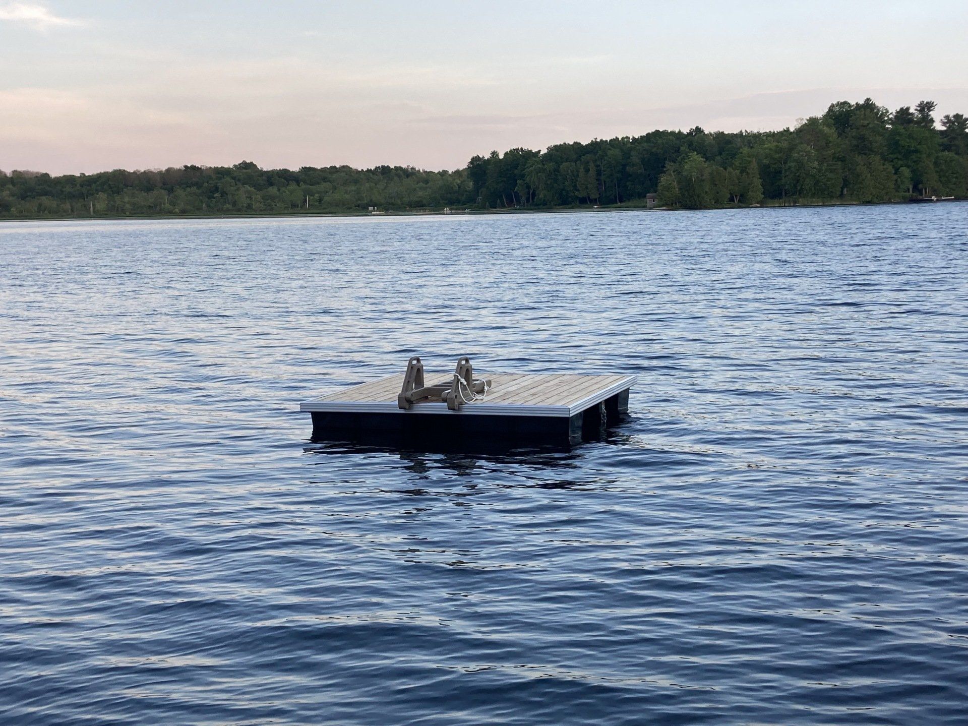 A dock is floating in the middle of a lake.