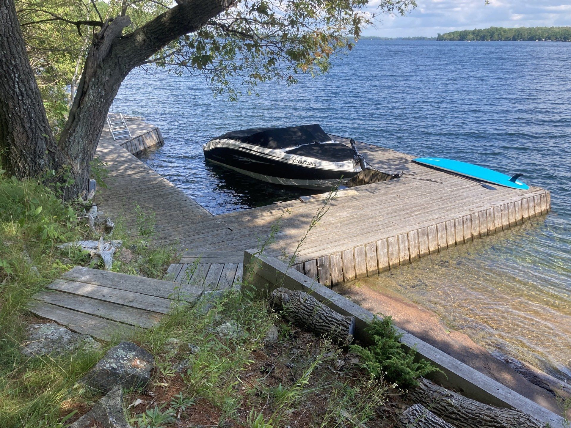 A boat is docked at a dock on a lake.