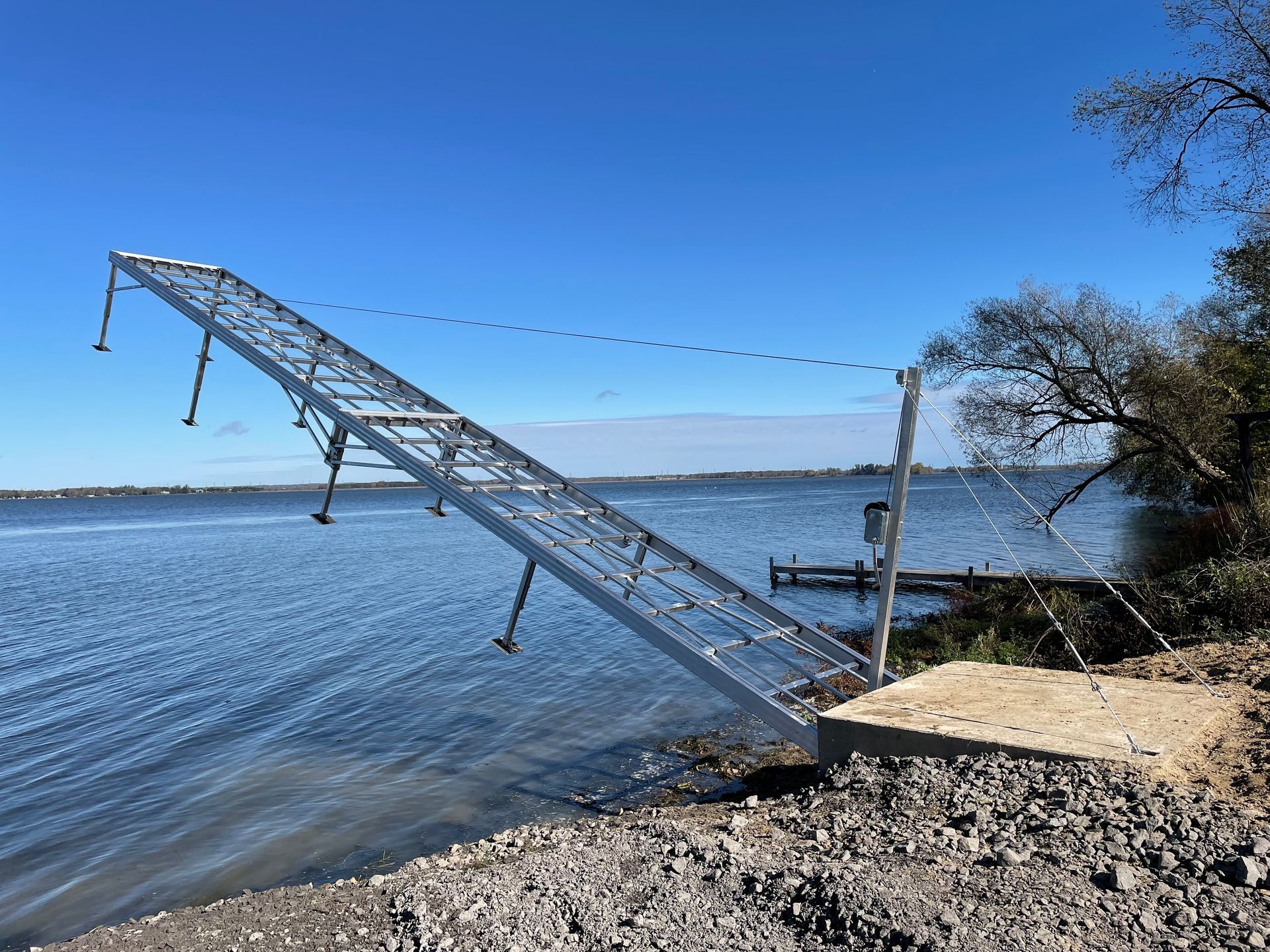A metal dock is sitting on the shore of a lake.