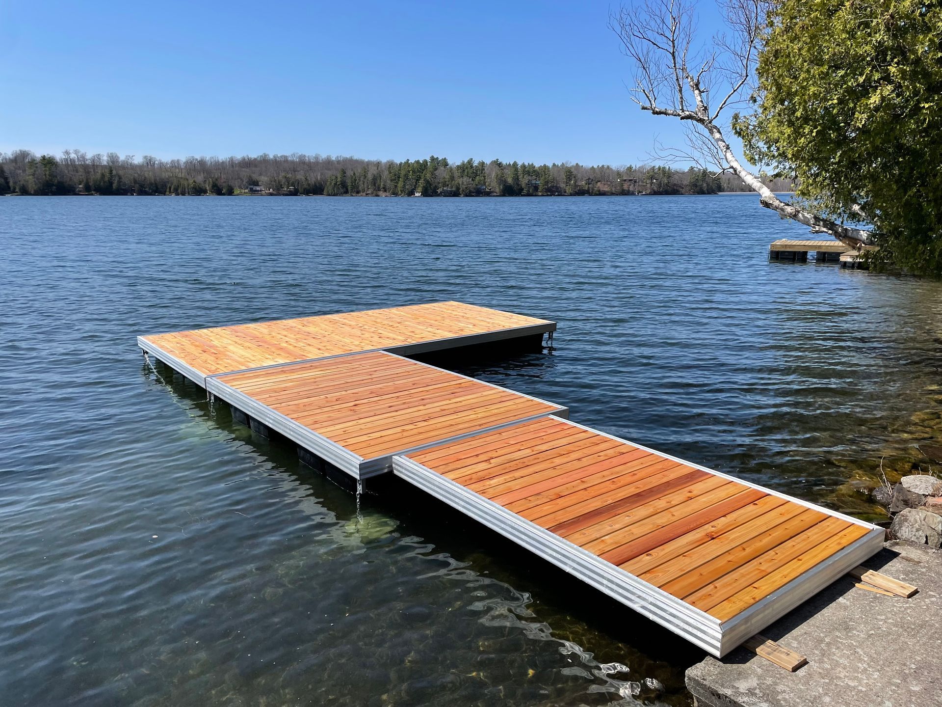 A wooden dock is sitting in the middle of a lake.
