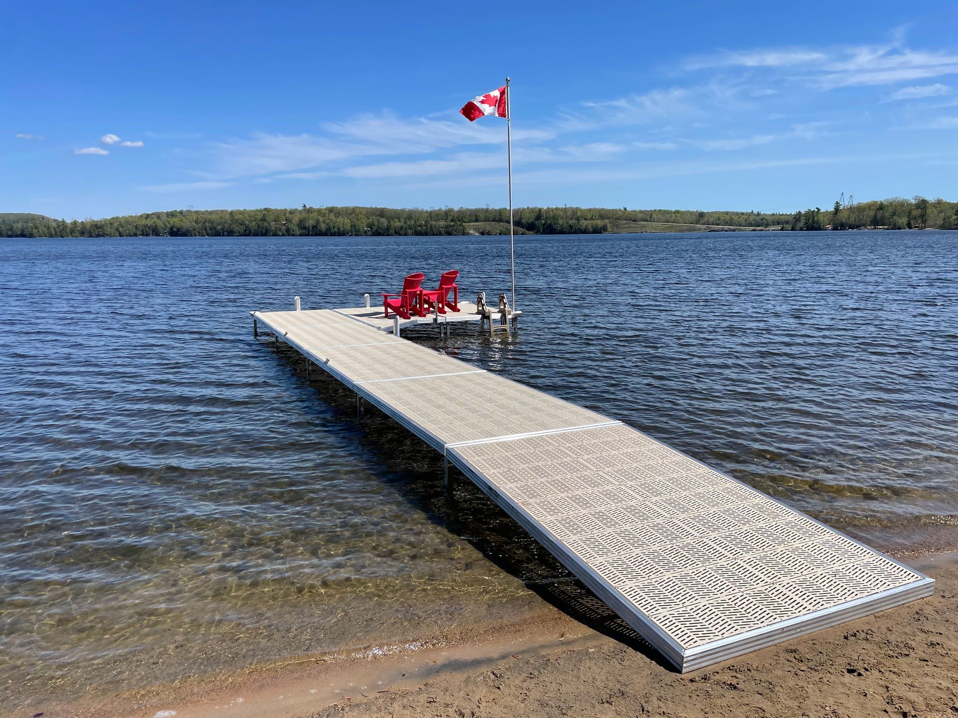 A dock with red chairs and a canadian flag on it