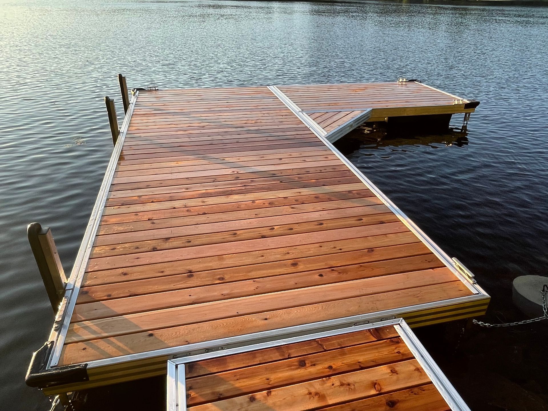 A wooden dock is sitting in the middle of a lake.