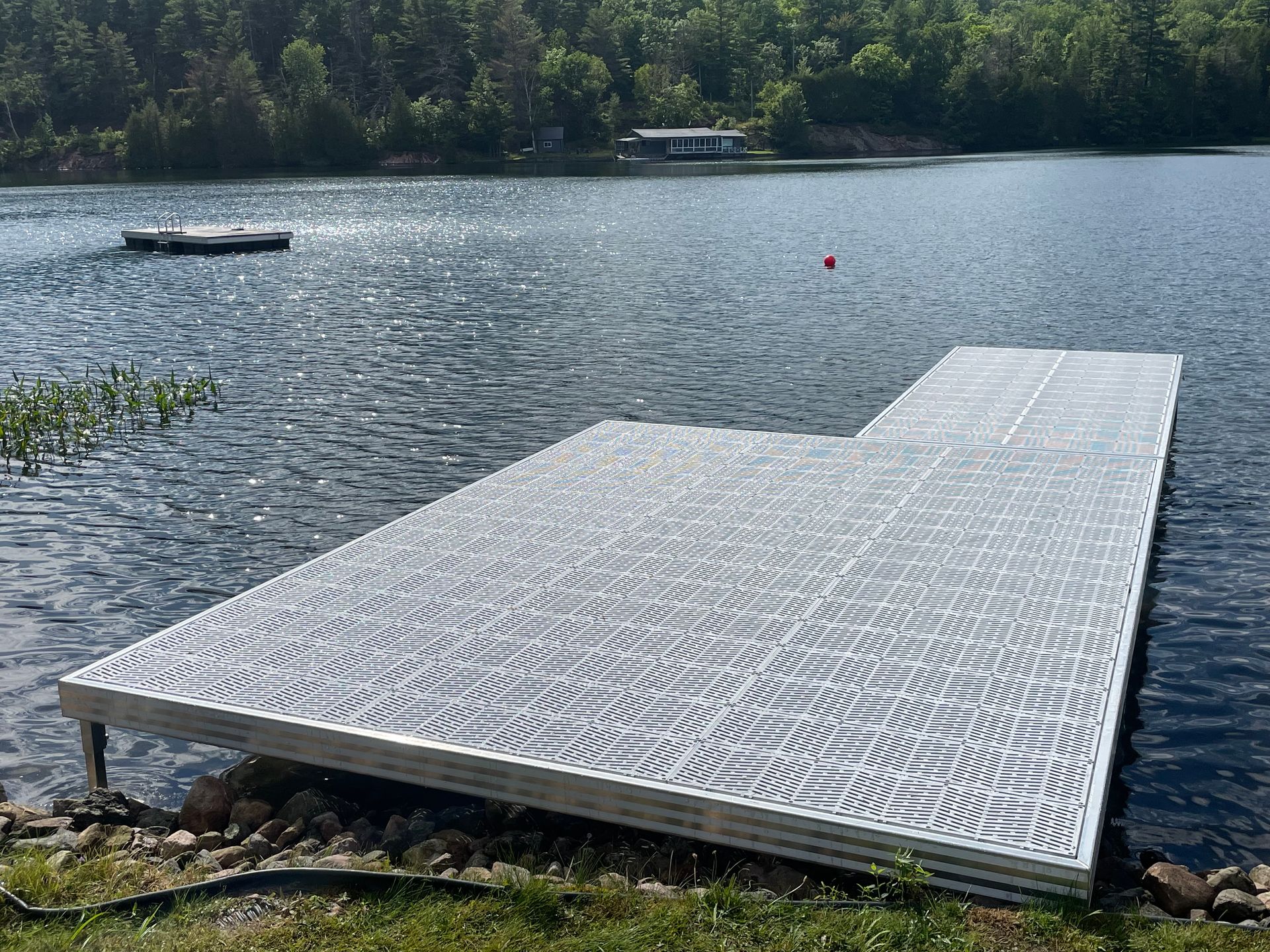 A dock is sitting on the shore of a lake.