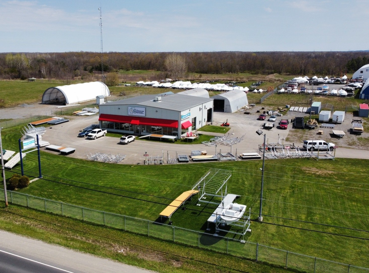 An aerial view of a large building with a lot of vehicles parked in front of it.