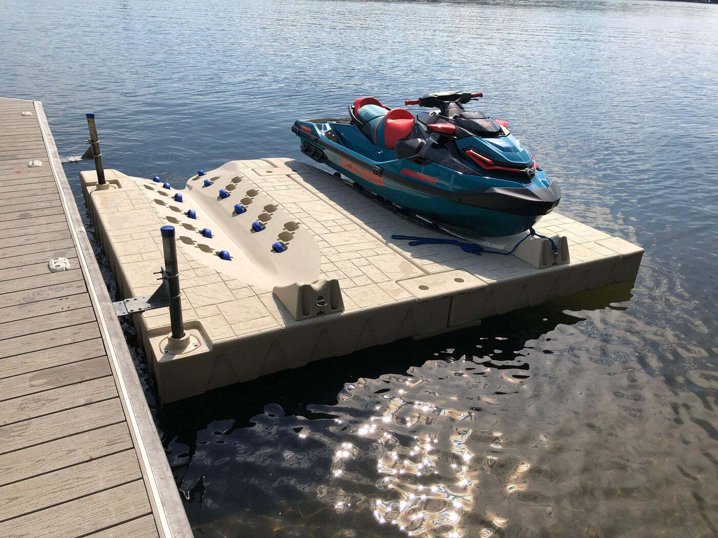 A jet ski is sitting on a dock in the water.