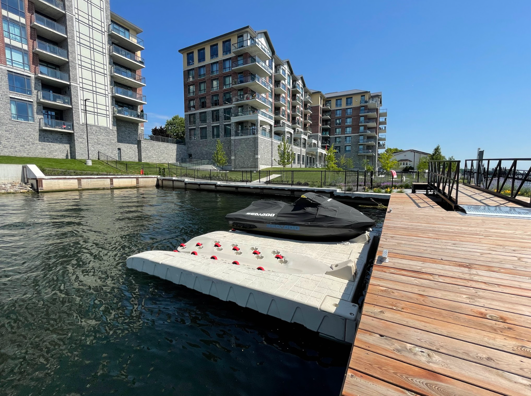 A jet ski is docked on a dock next to a body of water.