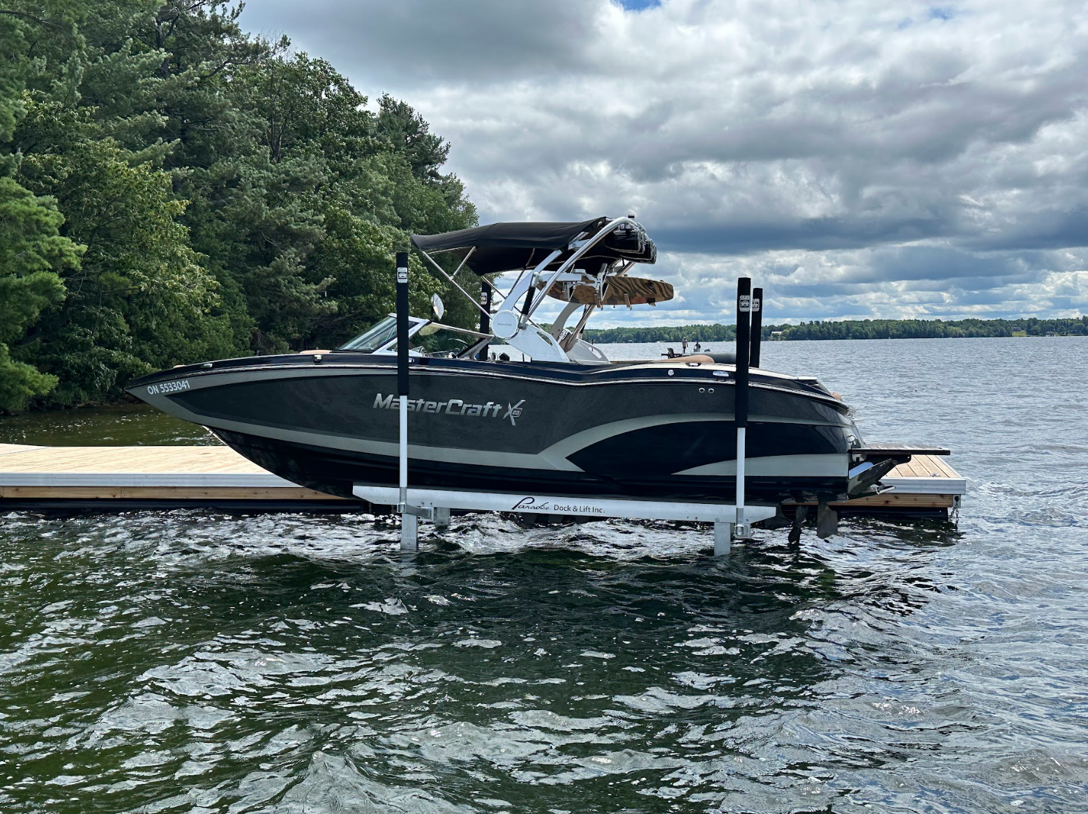 Boat on boat lift next to dock