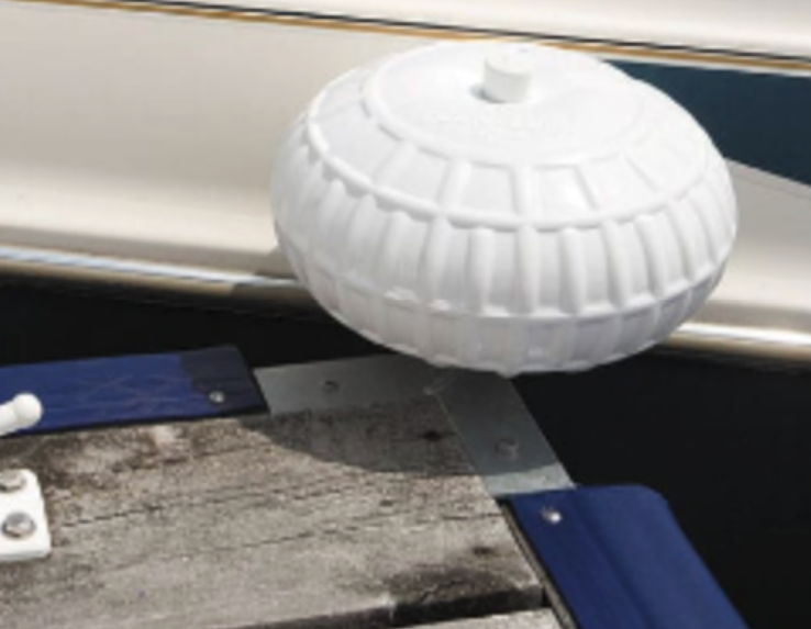 A white ball is attached to the side of a boat