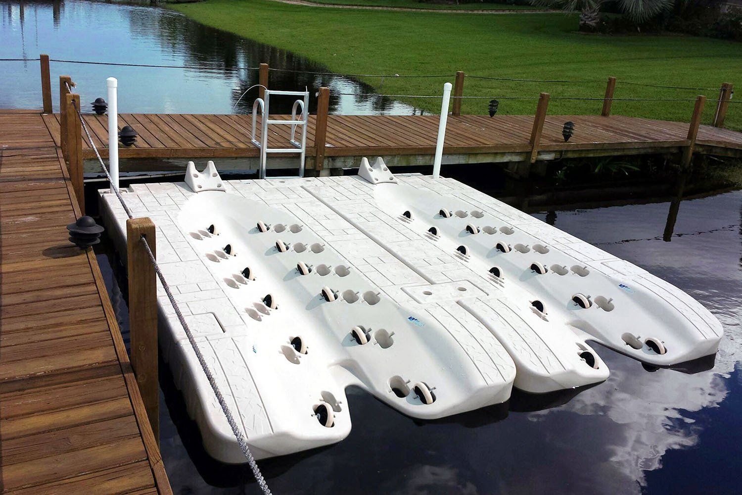 A wooden dock with a white boat on it