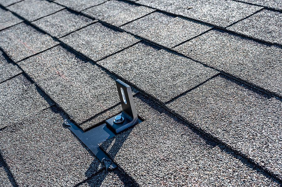 the roof of a house with a broken shingled roof