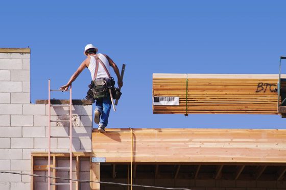 a man on a ladder working on a roof