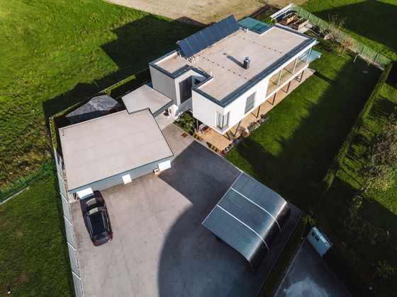 an aerial view of a house with a car parked in the drivewa