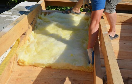 a man is putting insulation in a wooden box