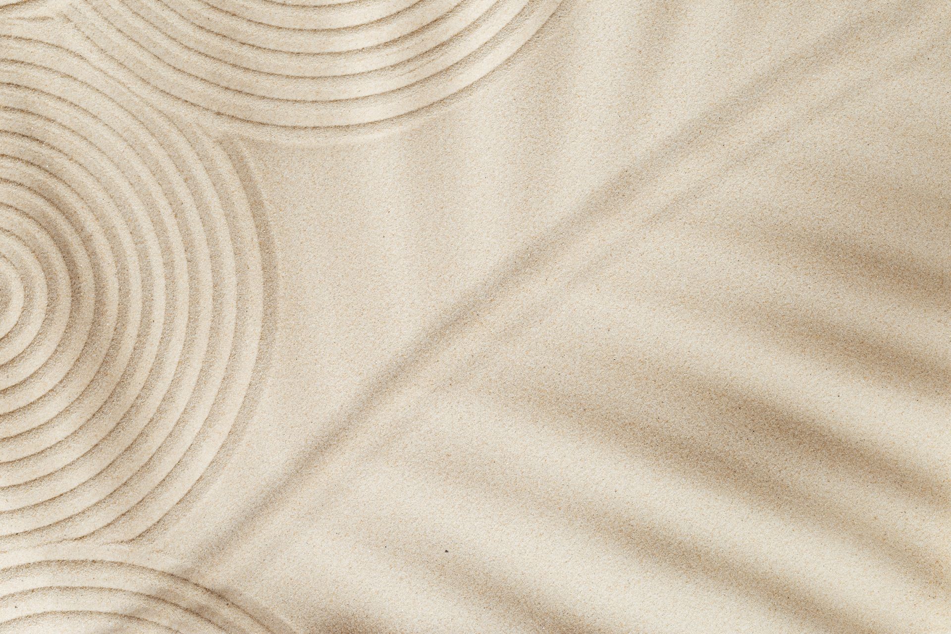 A close up of a sandy surface with circles in it.