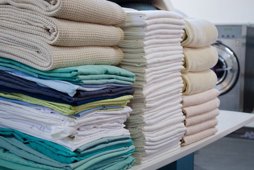 Stack of Folded Clean Sheets — Adamstown, NSW — Mattara Dry Cleaners
