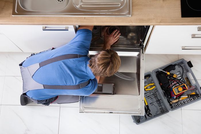 man fixing the dishwasher