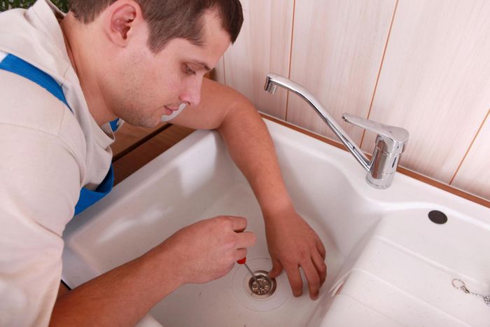 man fixing the sink