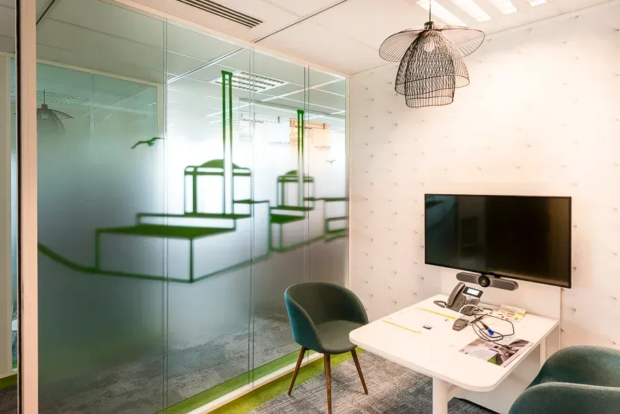 Une salle de conférence avec une table, des chaises et une télévision. Aménagement de bureaux et locaux professionnels - SPAC