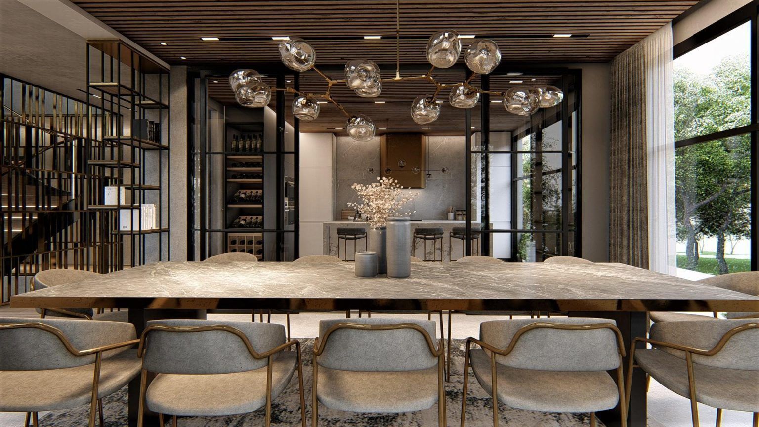Een eetkamer met een lange tafel en stoelen en een keuken op de achtergrond.