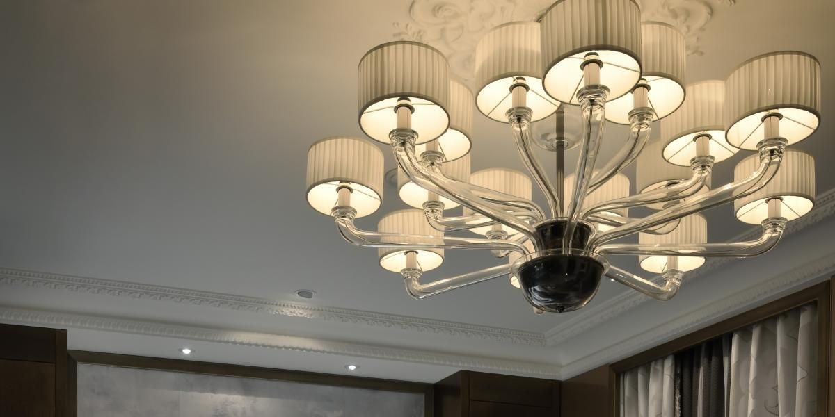Een grote kroonluchter hangt aan het plafond in een kamer.