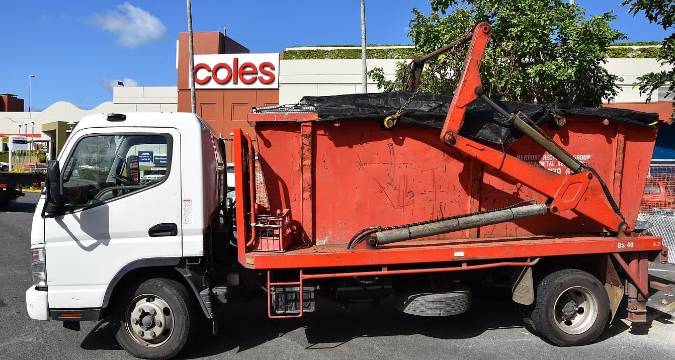 A Dump Truck is Parked in Front of a Coles Store — Newport Recycling in Woree, QLD