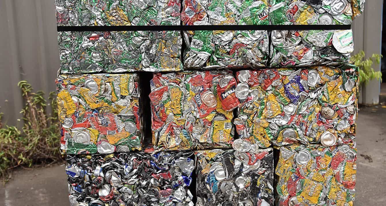 A Pile of Aluminum Cans Stacked on Top of Each Other — Newport Recycling in Woree, QLD